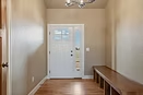 Triple Dot entry hall with a glazed front door and timber bench