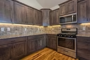Triple Dot kitchen with dark wood cabinetry and warm plank flooring