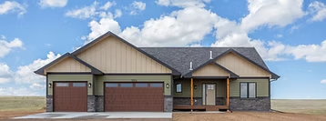 Single-story Triple Dot home beneath a wide Wyoming sky