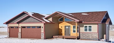 Bighorn home exterior in winter with stone accents and a covered entry