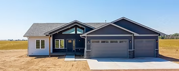 Cody home exterior with deep blue siding and a three-car garage