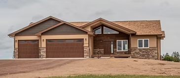 Diamondville home exterior with timber entry, stonework, and a three-car garage
