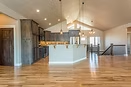 Open Triple Dot gathering room with a vaulted ceiling and central kitchen